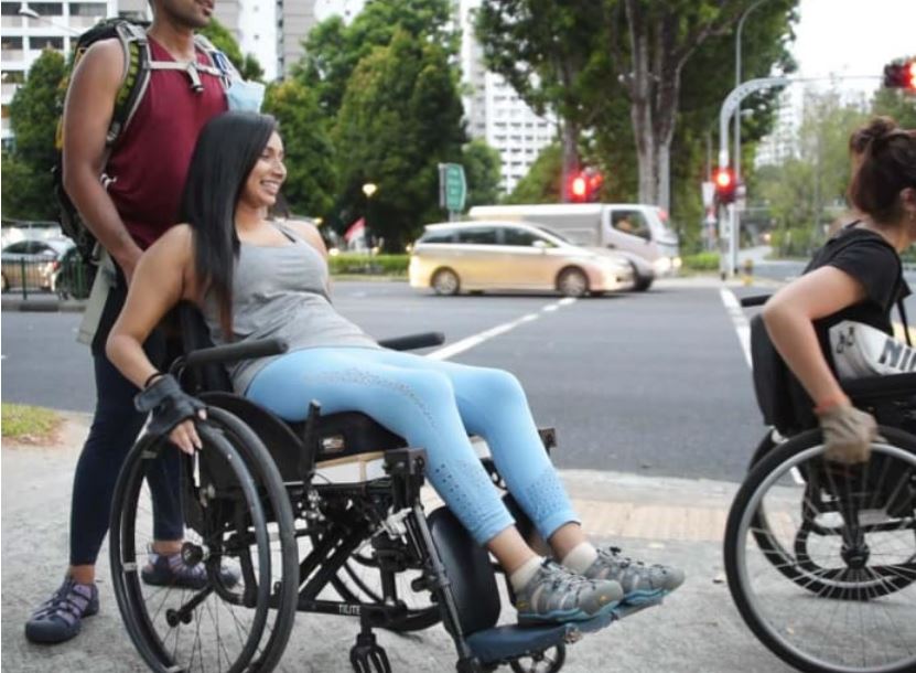 Photo shows Fathima Zohra on a wheelchair during the 72km wheelchair trek with a friend