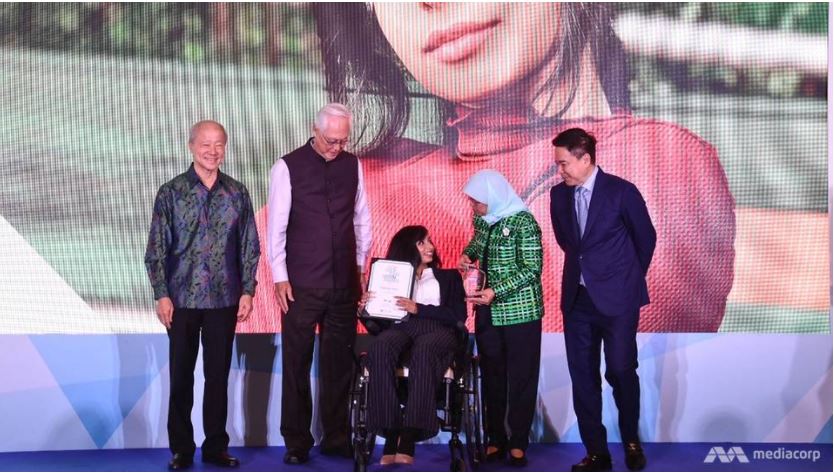 Photo shows Fathima Zohra receiving the Goh Chok Tong Enable Award 2019 (UBS Promise) from President Halimah Yacob.