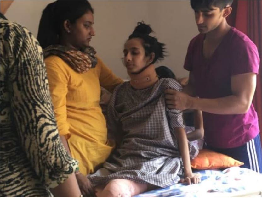 Photo shows Fathima Zohra's family helping her sit up on her bed