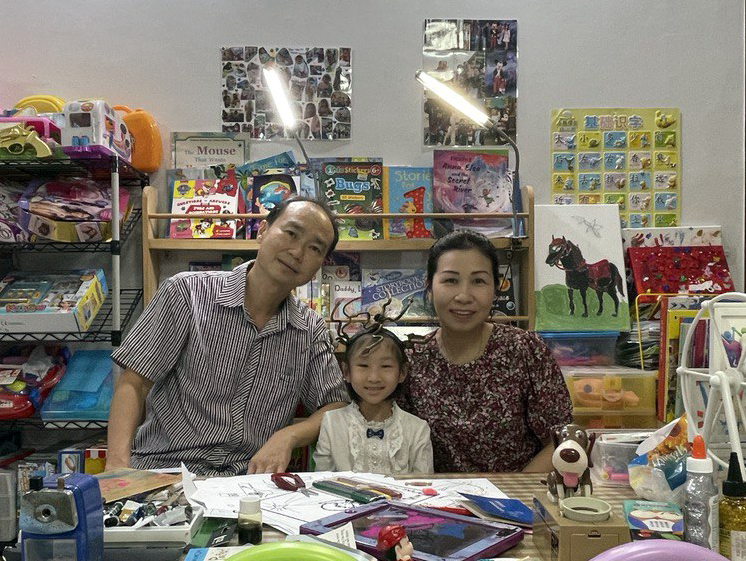Image shows beneficiary Ho Wen Xi with her father and mother