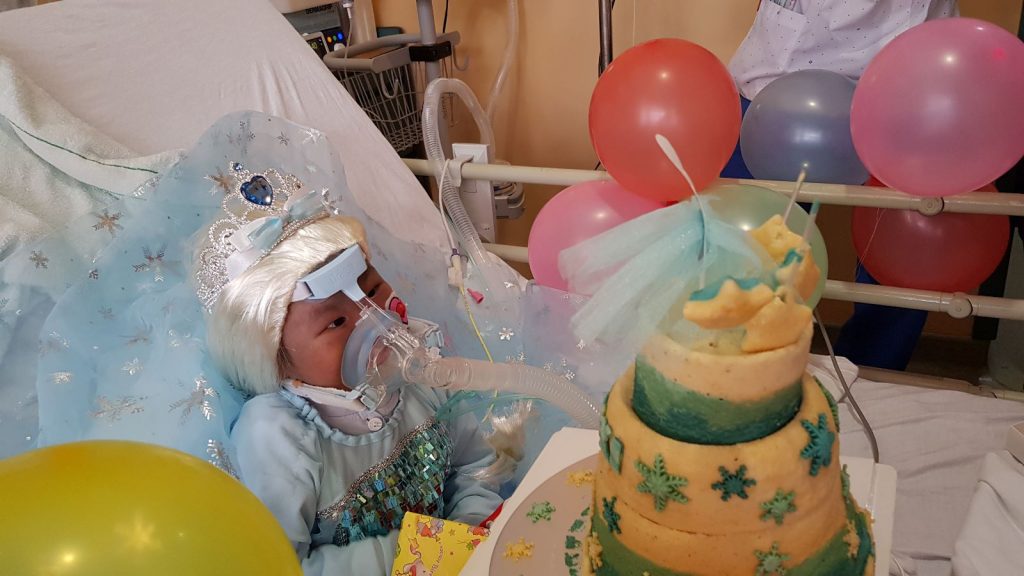 Image shows beneficiary Ho Wen Xi celebrating her fifth birthday in the hospital